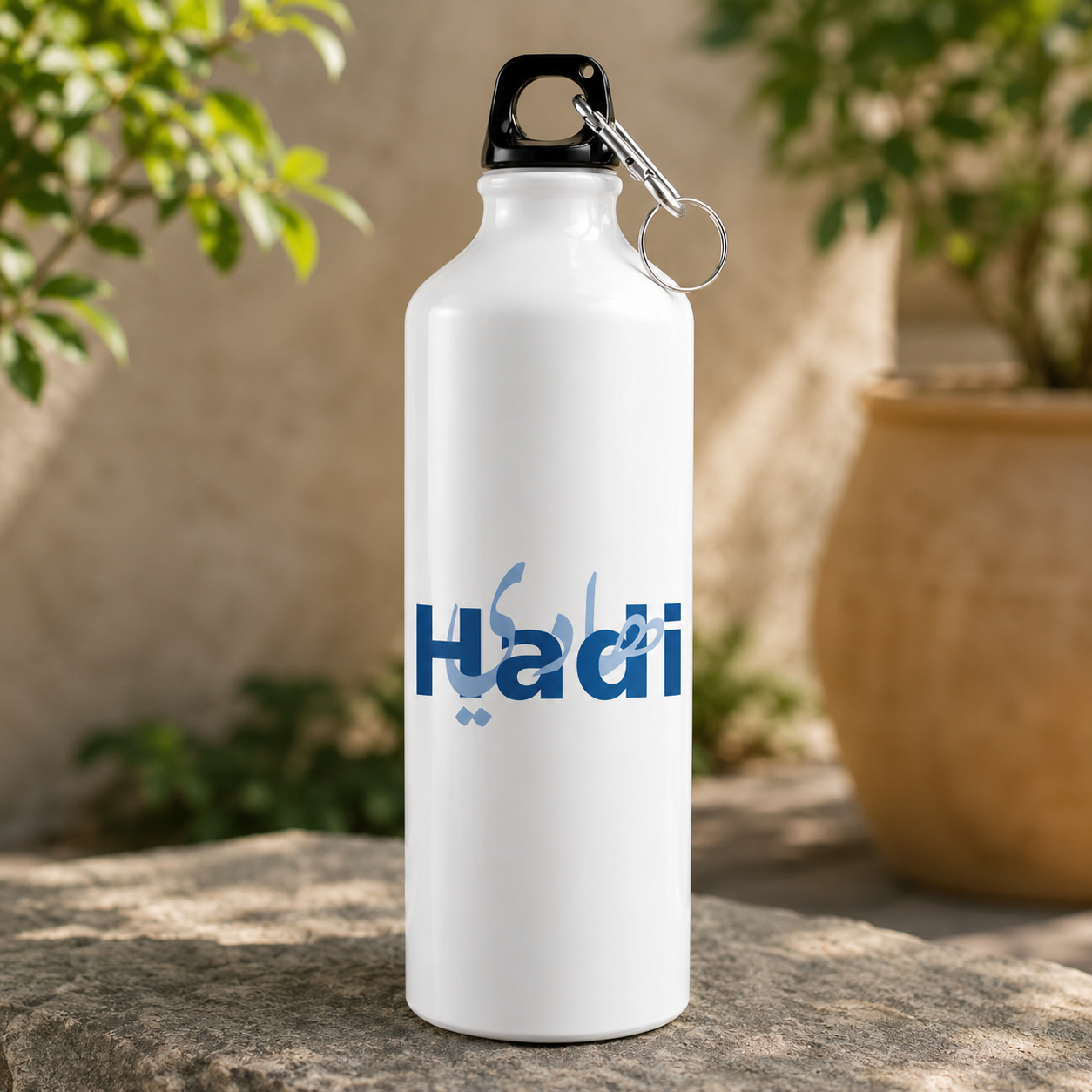 Hadi name water bottle in white with bold blue lettering and Arabic calligraphy design