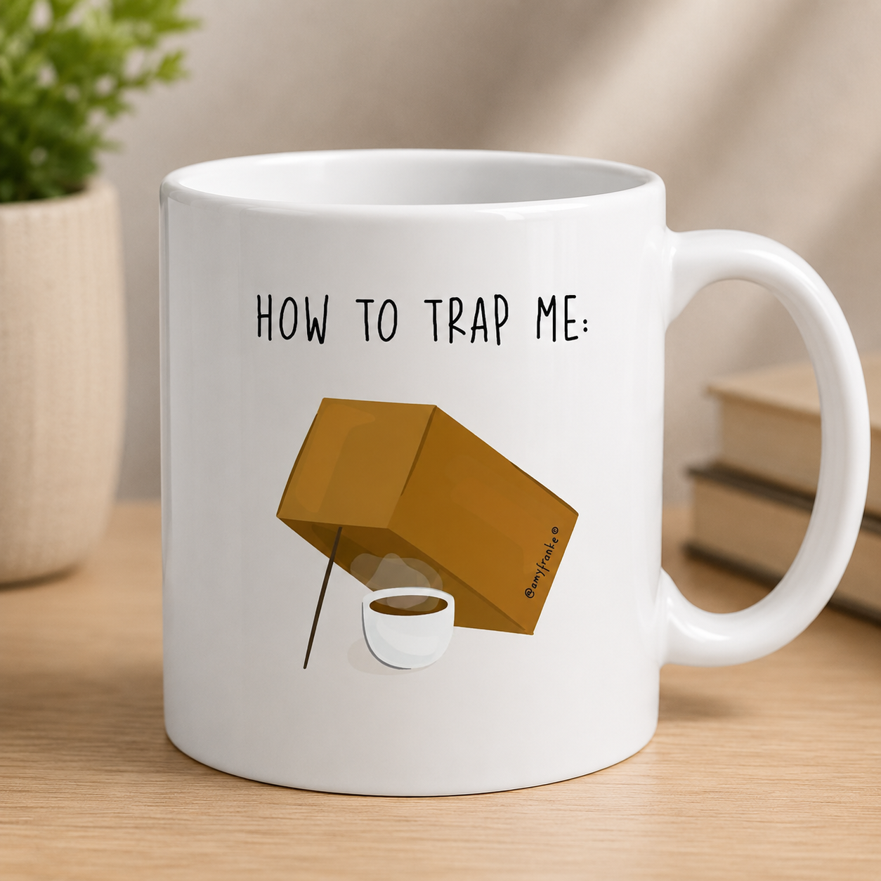 Funny coffee mug design showing a box trap baited with a cup of coffee and “How to Trap Me” text