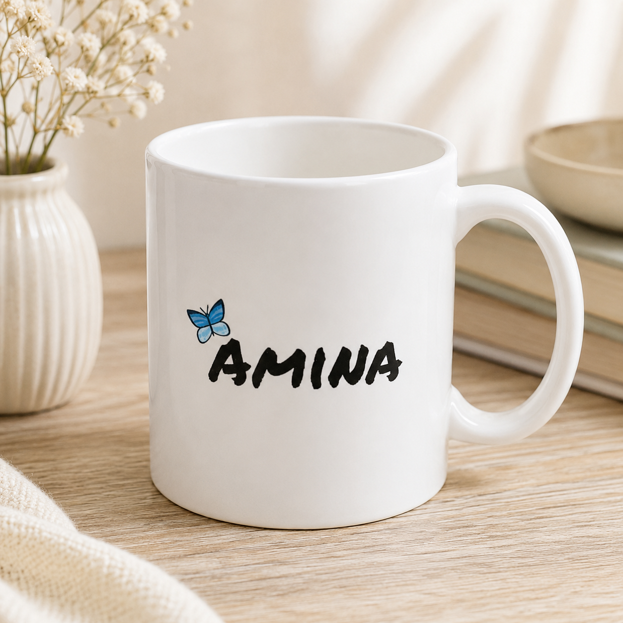 White personalized Amna name mug with black lettering and blue butterfly design