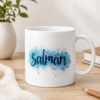White personalized Salman name mug with dark blue lettering and colorful watercolor splash design