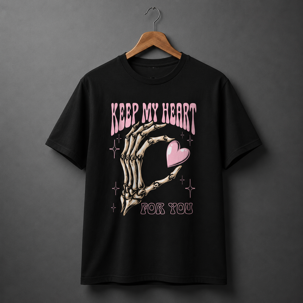 Black skeleton heart graphic T-shirt with pink heart and romantic text